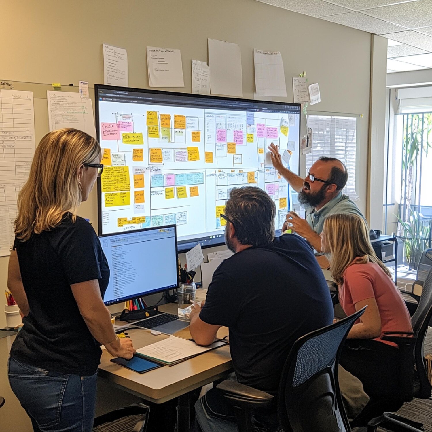 Cross-functional web team plans sprint deliverables and dependencies for a redesign