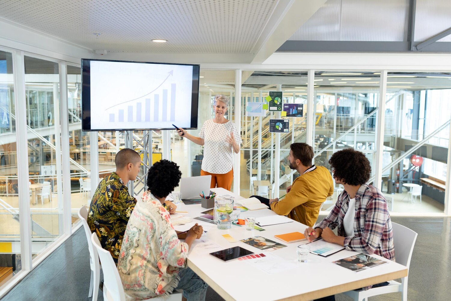 Cross‑functional team collaborating in a workshop to codify a scalable visual identity and workflow
