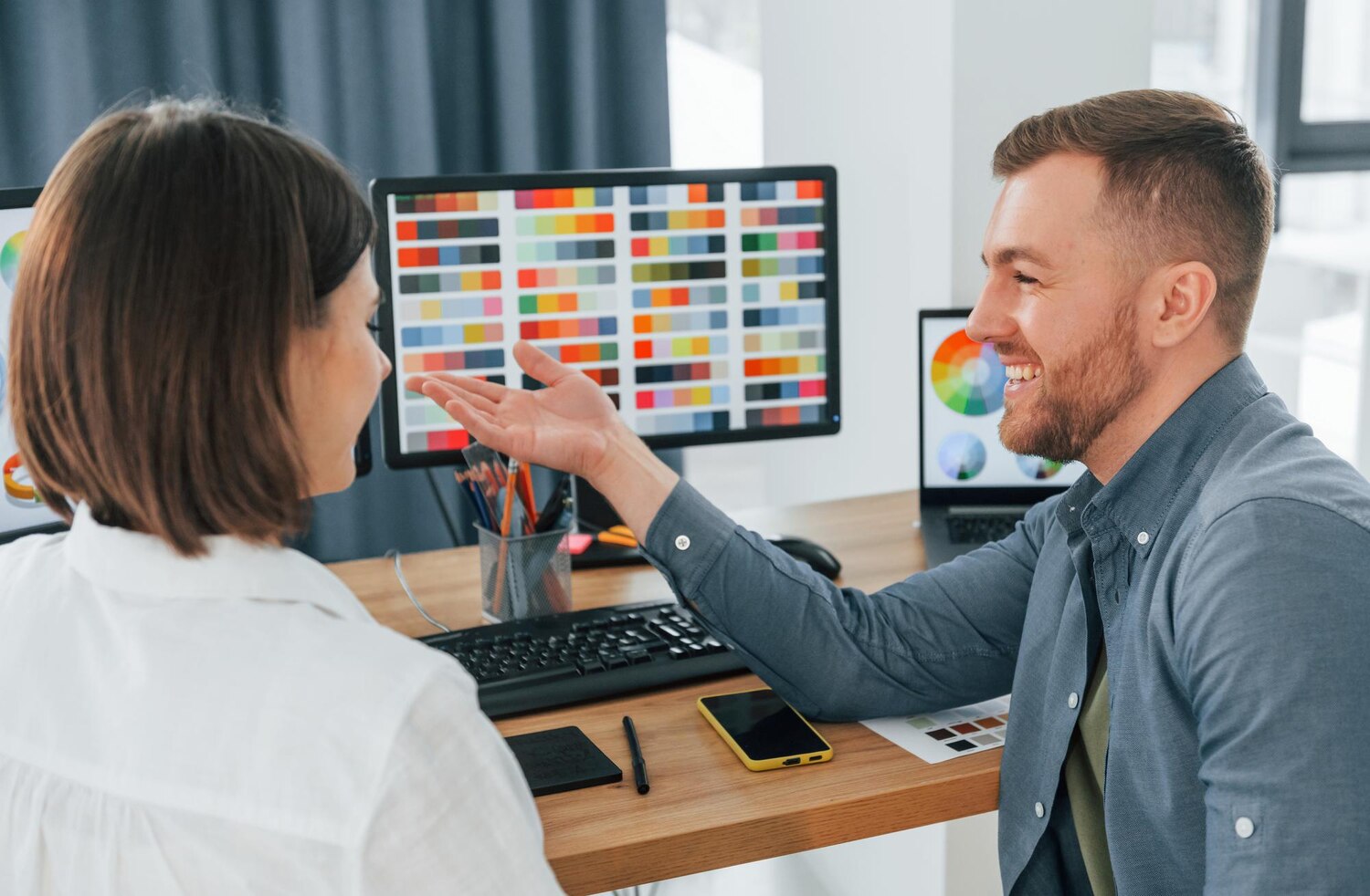 Developer reviewing design tokens and typographic scales alongside brand KPIs to evaluate the identity system’s impact