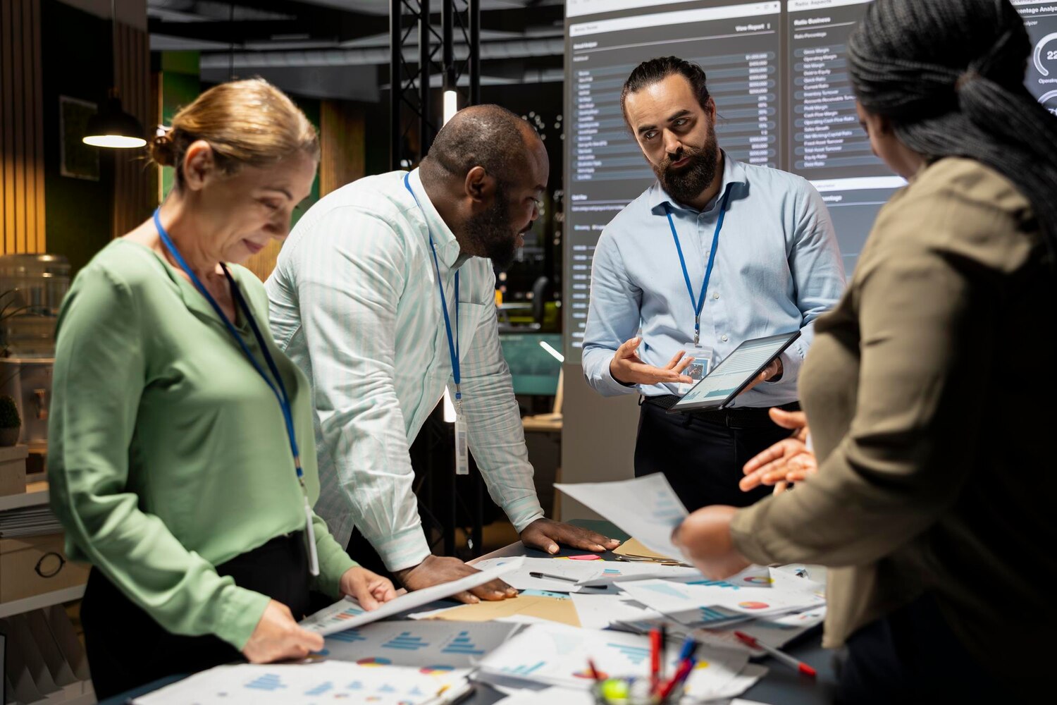 A cross-functional team collaborates around a system diagram mapping data pipelines and LLM services during an AI integration workshop
