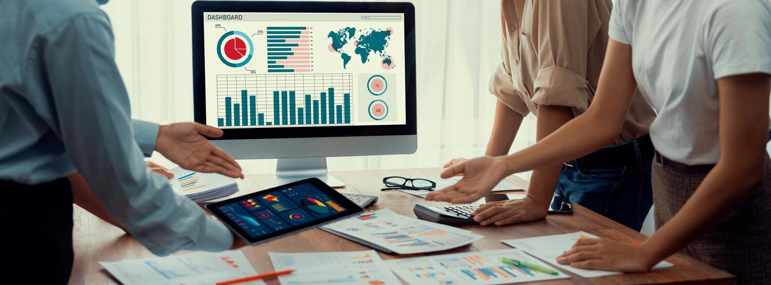 Team examines analytics dashboards to assess brand identity system consistency and performance across channels