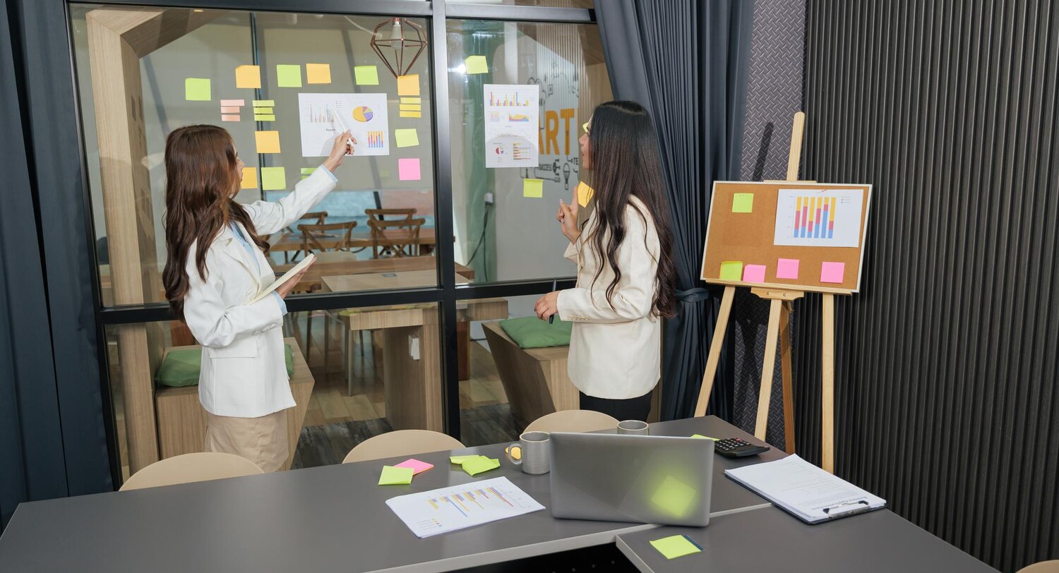 UX lead diagramming funnel drop-offs to explain conversion-focused web design decisions to product and engineering