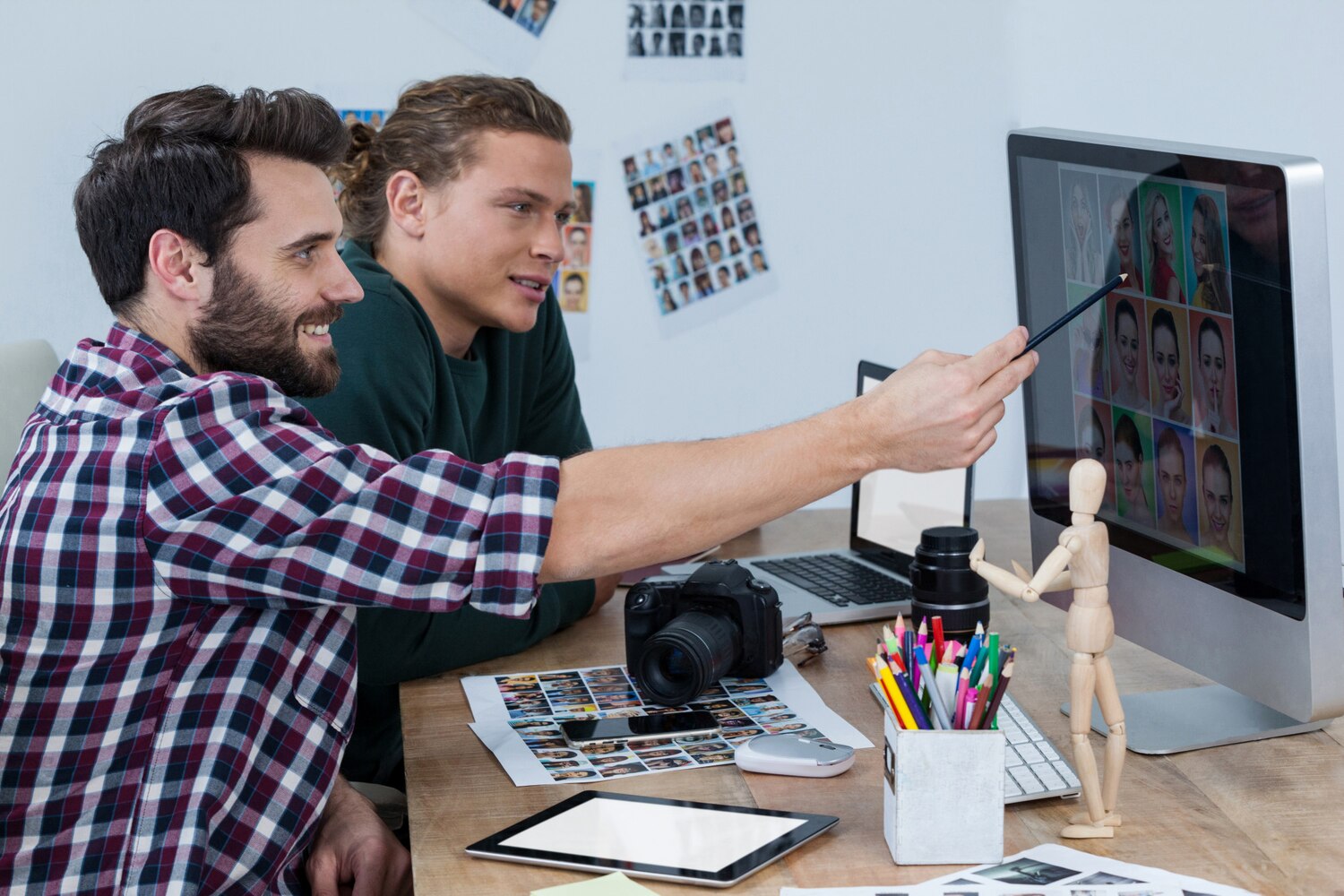 Designers and engineers collaborating on component standards and tokens for a scalable brand system